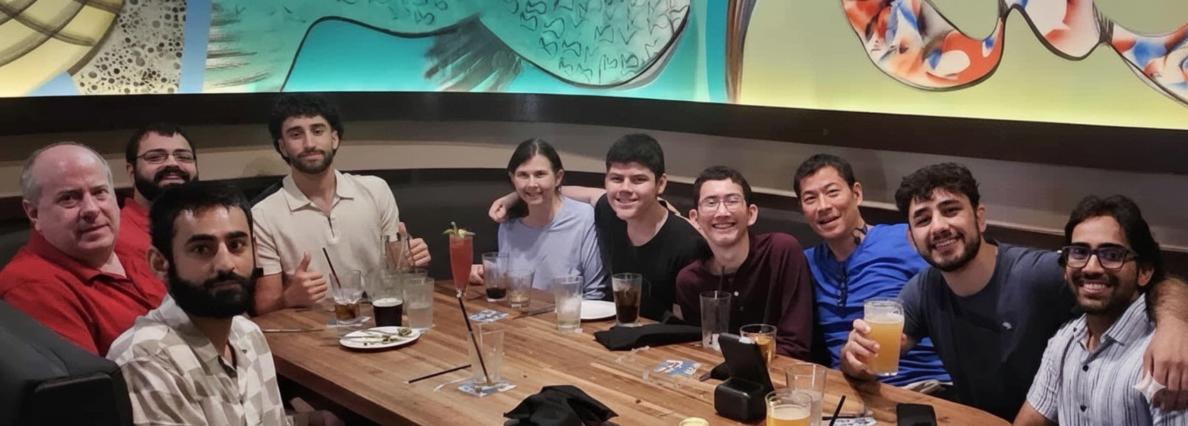 Four employees smiling in group photo